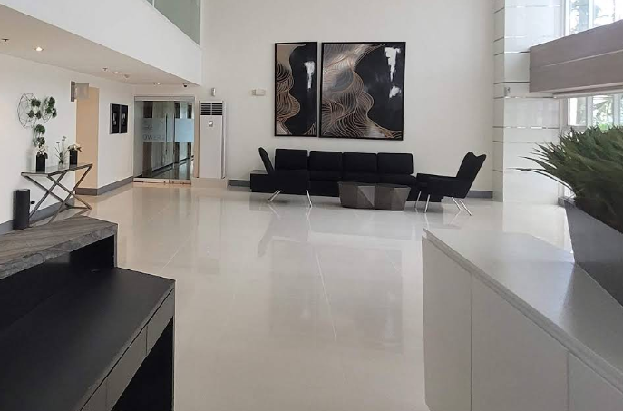 Neighbors chatting warmly in a bright condominium lobby